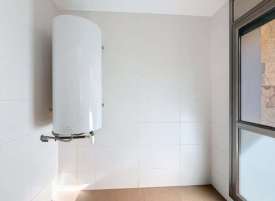 This modern space features a pristine white tiled wall, creating a clean and bright aesthetic.