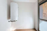 This modern space features a pristine white tiled wall, creating a clean and bright aesthetic.