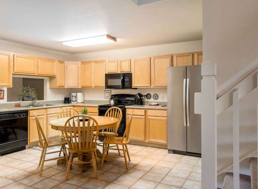 This charming kitchen features ample cabinet space, perfect for storage and organization.
