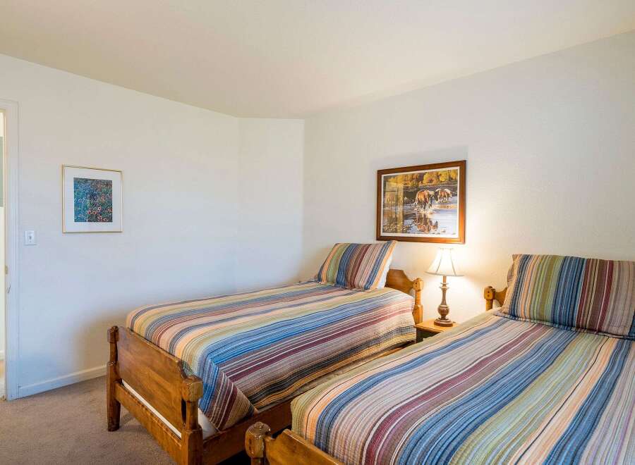This cozy bedroom features two twin beds, perfect for guests or family members.