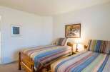 This cozy bedroom features two twin beds, perfect for guests or family members.