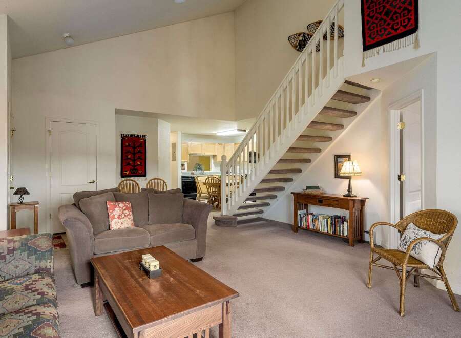 This inviting home features a spacious living area with a cozy sofa and a charming coffee table.