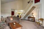 This inviting home features a spacious living area with a cozy sofa and a charming coffee table.