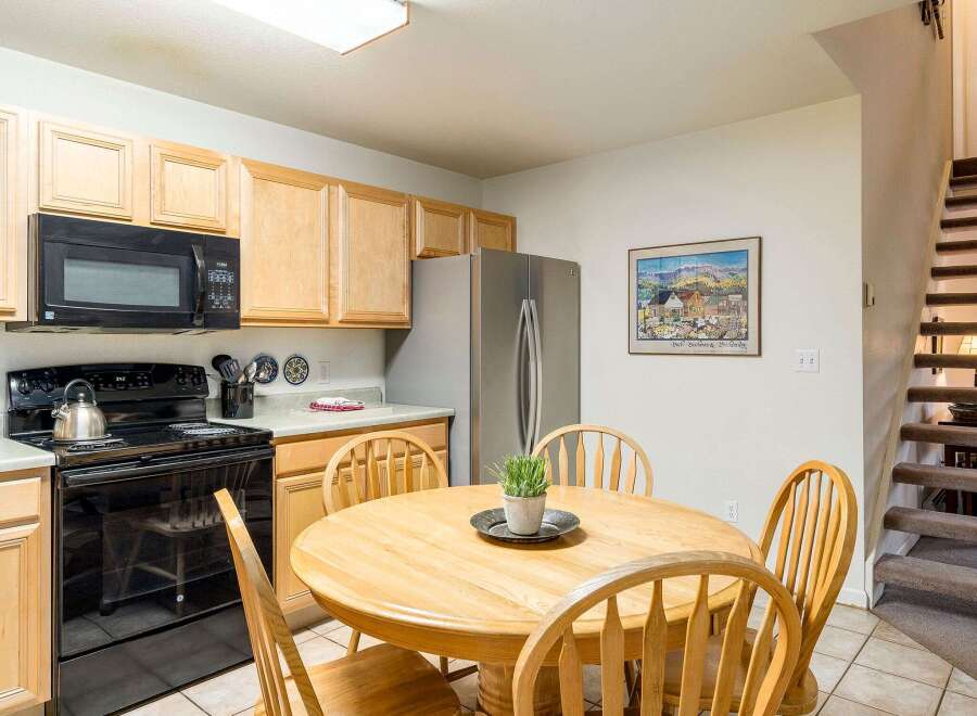 This charming kitchen features a cozy dining area perfect for family meals.