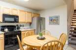 This charming kitchen features a cozy dining area perfect for family meals.