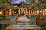 This stunning property boasts a grand entrance with a stone pathway leading to the front door.