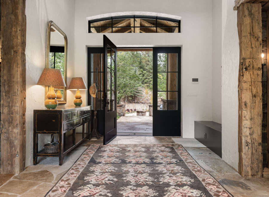 Step into luxury with this stunning entryway, showcasing a blend of rustic charm and modern elegance.