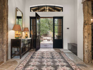 Step into luxury with this stunning entryway, showcasing a blend of rustic charm and modern elegance.