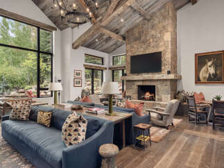 Experience luxury living in this stunning property featuring a cozy fireplace and a spacious living area.