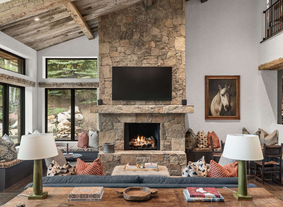Experience the epitome of luxury living in this stunning property, featuring a grand stone fireplace as the focal point.