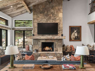 Experience the epitome of luxury living in this stunning property, featuring a grand stone fireplace as the focal point.