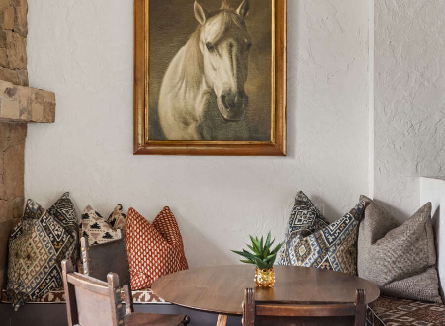 This charming dining area features a round wooden table, perfect for intimate gatherings.