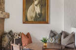 This charming dining area features a round wooden table, perfect for intimate gatherings.