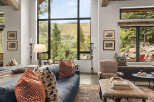 Experience luxury living with this stunning property, featuring a spacious living room with breathtaking mountain views.