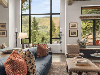 Experience luxury living with this stunning property, featuring a spacious living room with breathtaking mountain views.