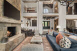 This stunning property boasts a grand living space with a stone fireplace, creating a warm and inviting atmosphere.