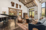 This stunning property boasts a luxurious living space with a grand piano, perfect for entertaining.