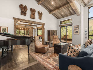 This stunning property boasts a luxurious living space with a grand piano, perfect for entertaining.