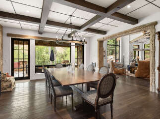 This stunning dining room showcases a perfect blend of rustic charm and modern elegance.