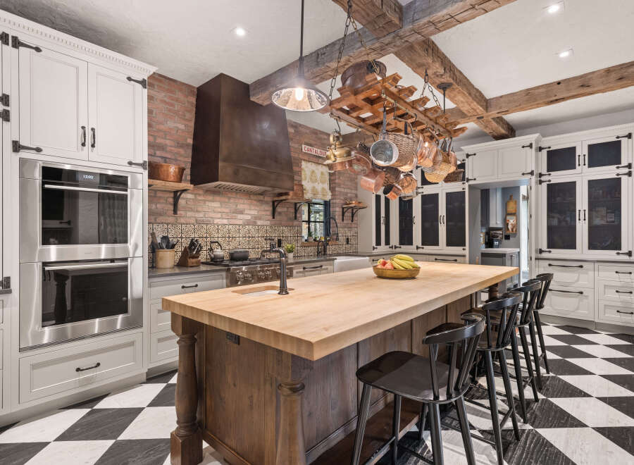This stunning kitchen boasts a rustic yet elegant design, perfect for culinary enthusiasts.