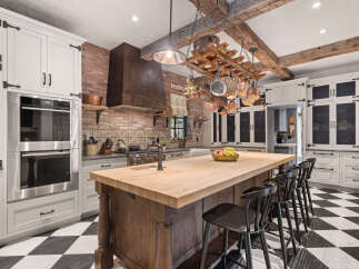 This stunning kitchen boasts a rustic yet elegant design, perfect for culinary enthusiasts.