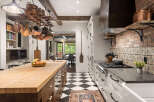 This stunning kitchen boasts a blend of rustic charm and modern elegance, perfect for culinary enthusiasts.