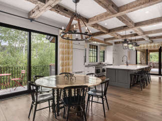This stunning kitchen and dining area boasts a rustic yet modern design, perfect for entertaining.