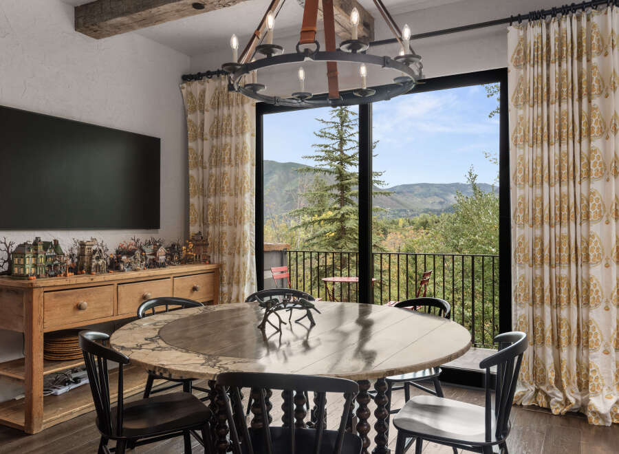 This stunning dining room boasts a unique blend of rustic charm and modern elegance.