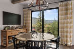 This stunning dining room boasts a unique blend of rustic charm and modern elegance.