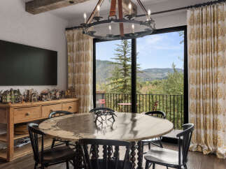 This stunning dining room boasts a unique blend of rustic charm and modern elegance.