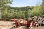 Enjoy the ultimate outdoor living experience with this stunning property, featuring a cozy fire pit surrounded by comfortable seating.