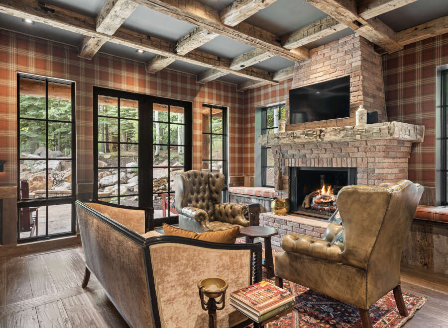 This stunning living room boasts a cozy ambiance with its brick fireplace, perfect for those chilly evenings.