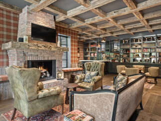 This stunning living space features a cozy brick fireplace, perfect for relaxing evenings.