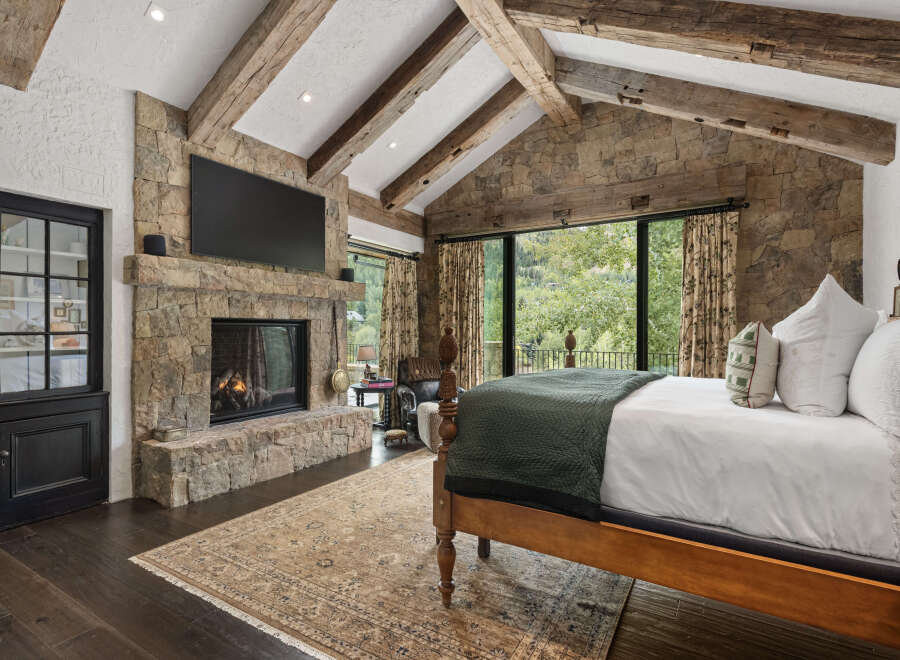 This stunning bedroom features a cozy fireplace, perfect for chilly evenings.
