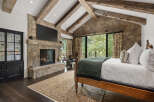 This stunning bedroom features a cozy fireplace, perfect for chilly evenings.