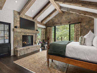 This stunning bedroom features a cozy fireplace, perfect for chilly evenings.