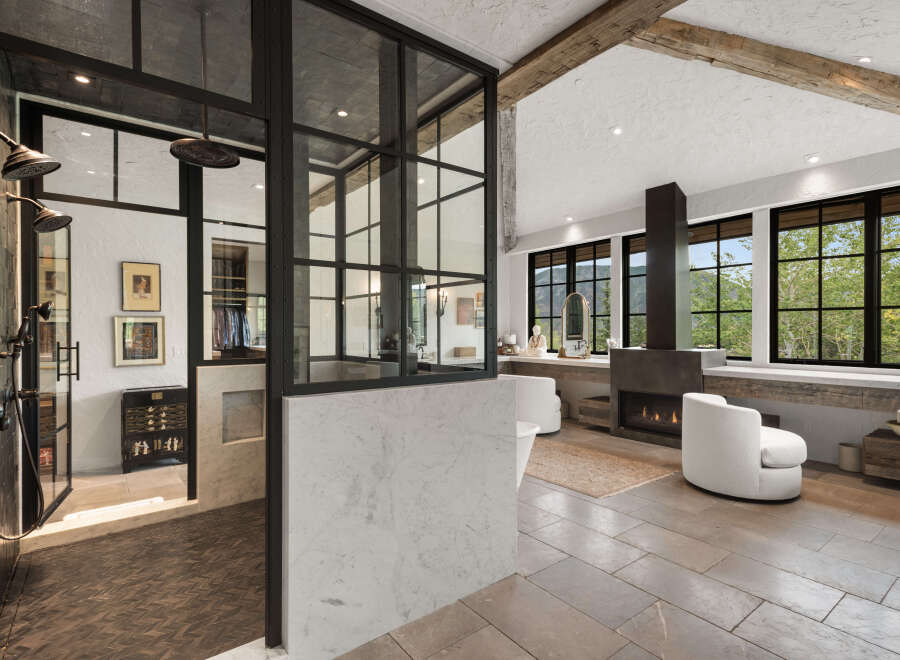 Experience luxury in this stunning bathroom featuring a modern design with a touch of rustic charm.