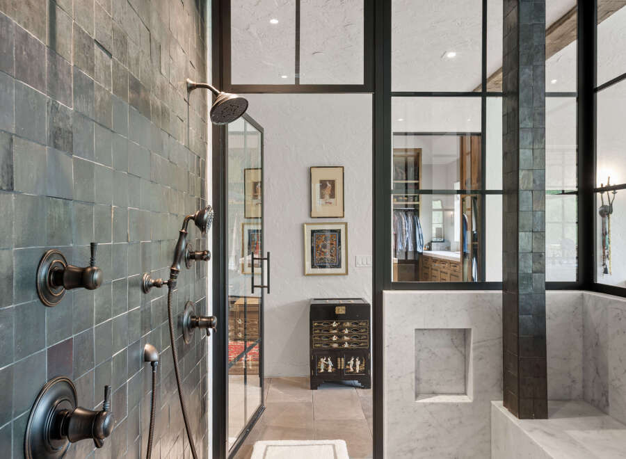 Step into luxury with this stunning bathroom, showcasing a modern design with dark tile accents.