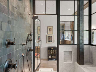 Step into luxury with this stunning bathroom, showcasing a modern design with dark tile accents.