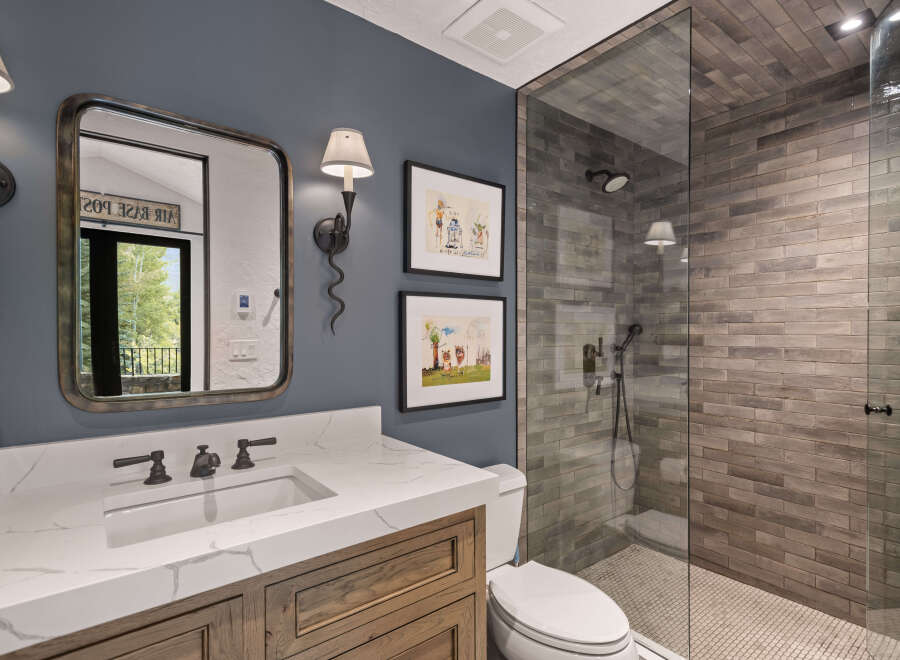 This stunning bathroom features a modern design with a spacious walk-in shower and elegant vanity.
