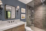 This stunning bathroom features a modern design with a spacious walk-in shower and elegant vanity.