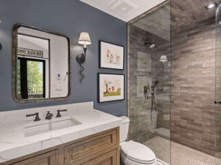 This stunning bathroom features a modern design with a spacious walk-in shower and elegant vanity.