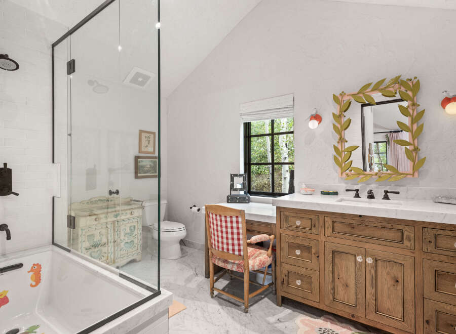 This charming bathroom features a unique blend of rustic and elegant design elements.