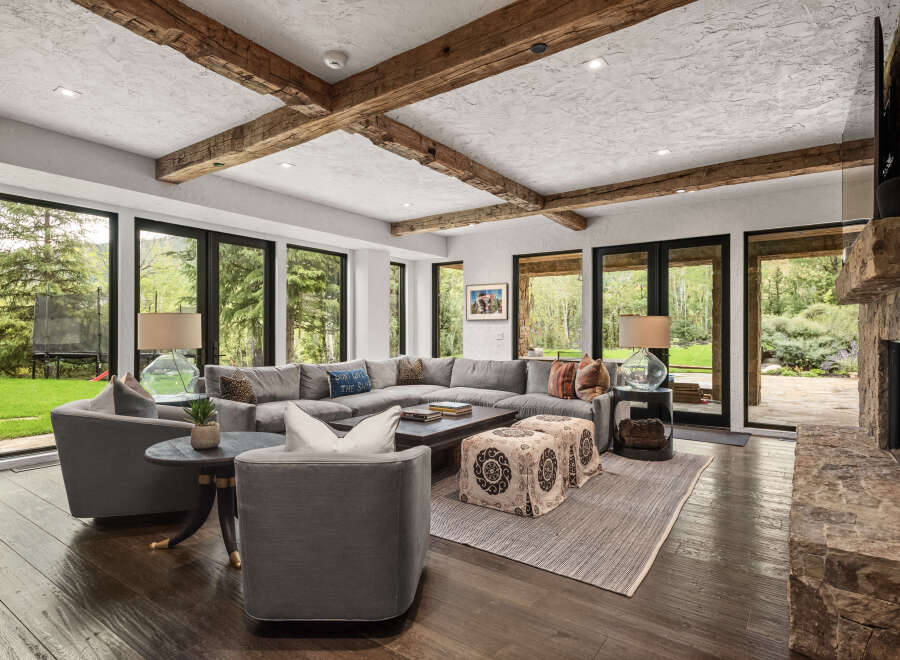 Step into luxury with this stunning living room, featuring a spacious sectional sofa and a cozy fireplace.