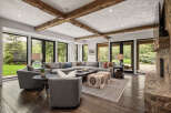 Step into luxury with this stunning living room, featuring a spacious sectional sofa and a cozy fireplace.