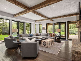Step into luxury with this stunning living room, featuring a spacious sectional sofa and a cozy fireplace.