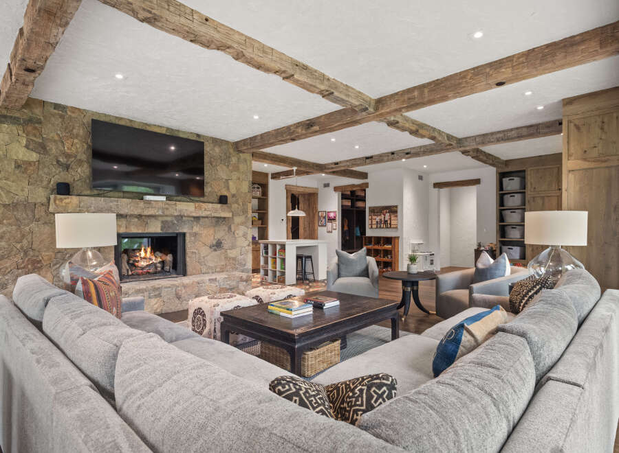 Experience luxury living in this stunning home featuring a cozy fireplace and a spacious, comfortable sectional sofa.