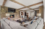 Experience luxury living in this stunning home featuring a cozy fireplace and a spacious, comfortable sectional sofa.