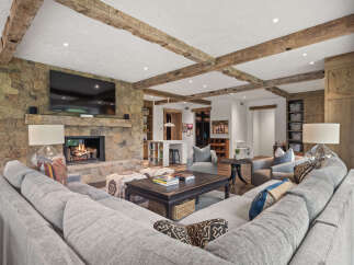 Experience luxury living in this stunning home featuring a cozy fireplace and a spacious, comfortable sectional sofa.