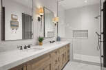 This luxurious bathroom features a stunning marble countertop and a custom wooden vanity, creating a spa-like atmosphere.
